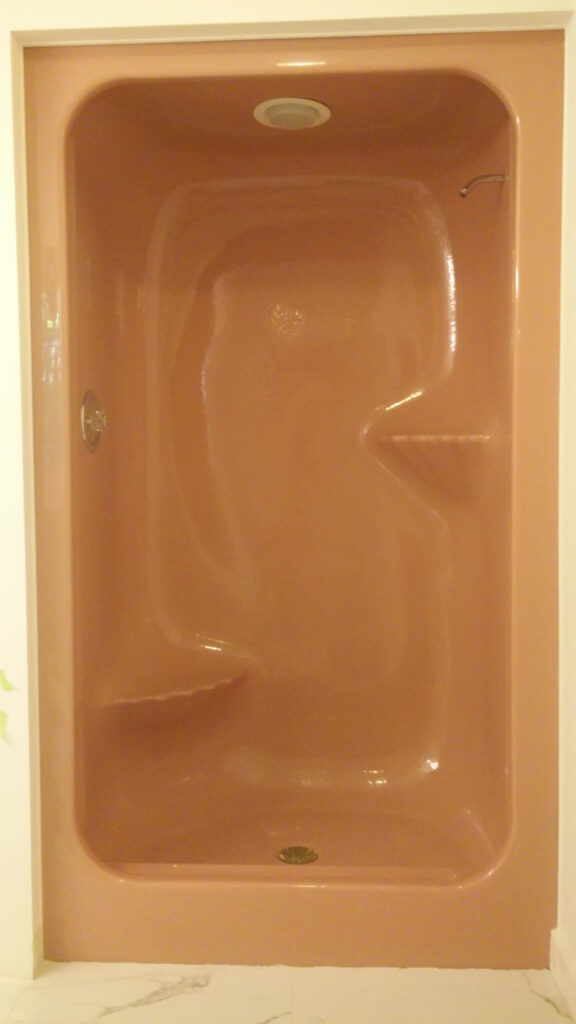 Old pink enclosed shower before refinishing